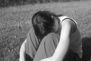 sad alone woman in field